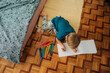 © Olga Moreira/Stocksy - Kid drawing in a sketchbook in bedroom