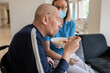 © Hernandez & Sorokina/Stocksy - Patient Eating Porridge, Nurse Is Near
