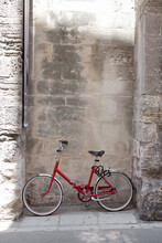 Red Vintage Bicycle Parked Outside A Picturesque Wall