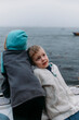 © Amanda Voelker/Stocksy - A young brother leans against his sister on a boat