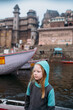 © Amanda Voelker/Stocksy - Portrait of a little girl on the boat along the banks of the Ganges