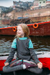 © Amanda Voelker/Stocksy - A little girl practicing yoga on a boat in the ganges