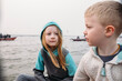 © Amanda Voelker/Stocksy - Two young children together on a boat at sunrise the Ganges