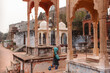 © Amanda Voelker/Stocksy - A little girl wandering around the tombs of a temple in rural India