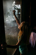 © Amanda Voelker/Stocksy - A young girl draws on a steamy window