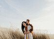 © Brianna Lee/Stocksy - Couple in sand dunes