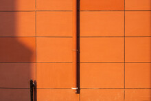 Drain On Orange Wall