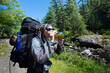 © JP Danko/Stocksy - Woman Taking Drink on Portage During Back Country Canoe Trip to Northern Lake