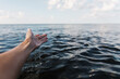 © Kelly Knox/Stocksy - woman's hand over water