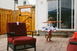 © Maria Manco/Stocksy - A girl twirls in her summer dress outside on patio