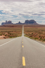 Long Open Desert Road In Monument Valley