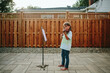 © Maria Manco/Stocksy - little girl plays the violin outside