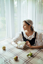 Pensive Romantic Girl In Retro Outfit Looks Out The Window