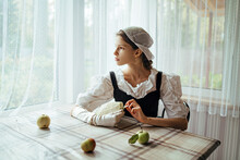 Romantic Young Woman In Retro Outfit Dreaming Near Window
