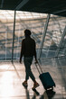 © Alina Hvostikova/Stocksy - Unrecognizable traveler walking in modern airport