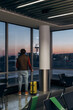 © Alina Hvostikova/Stocksy - Man in mask in lounge room of airport