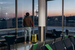 © Alina Hvostikova/Stocksy - Man in mask in lounge room of airport