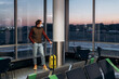 © Alina Hvostikova/Stocksy - Man in mask in lounge room of airport