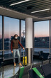 © Alina Hvostikova/Stocksy - Man in mask in lounge room of airport