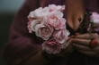 © Kim Jay Photography/Stocksy - Woman holding pink flowers