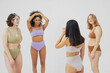 © Ivan Ozerov/Stocksy - group of multiracial women in colored underwear on gray background
