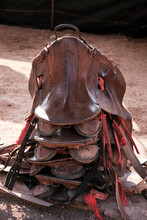 Closeup Of Saddles Stacked On The Ground At The Horse Farm