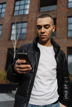 Man Using A Mobile Phone Outdoor On The City 