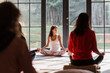 © Milles Studio/Stocksy - Ethnic instructor meditating with group in studio