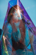 Woman Wrapped In Iridescent Film
