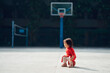 © Pansfun Images/Stocksy - little baby girl playing basketball outdoors