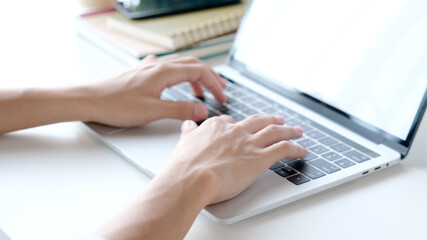 Wall Mural - close up of man hand typing laptop computer while working at home office, student college online stu