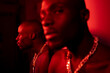 © Luis Velasco/Stocksy - Portrait With Reflection Of A Black Man Under Red Lighst.