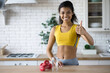 Portrait of African American beautiful young fitness trainer woman shows gesture good, standing at home kitchen, looking at the camera, healthy lifestyle, fitness at home online