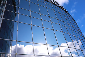 Wall Mural - Architectural detail of the facade with multiple reflections of other buildings and the sun. Modern building. Architecture background