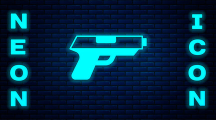 Sticker - Glowing neon Pistol or gun icon isolated on brick wall background. Police or military handgun. Small firearm. Vector