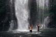 © Alexander Grabchilev/Stocksy - Tourists Looking At Waterfall In Jungle