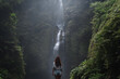 © Alexander Grabchilev/Stocksy - Tourist woman explore waterfall in a jungle