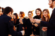 © sofie delauw/Stocksy - Crop happy colleagues with sparklers during festive event outdoors