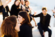 © sofie delauw/Stocksy - Crop content colleagues celebrating festive event on rooftop