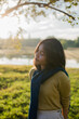 © Chalit Saphaphak/Stocksy - Asian lady in meadow