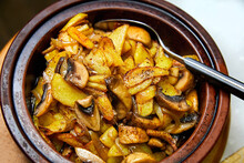 Potatoes With Mushrooms Baked In A Pot. Close-up, Selective Focus