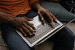 © VICTOR TORRES/Stocksy - Anonymous black man's hands typing on modern laptop