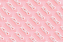 XOXO - Hugs And Kisses Abbreviation- 3D Render Of The Word "XOXO" On A Pink Background With Red Hearts 