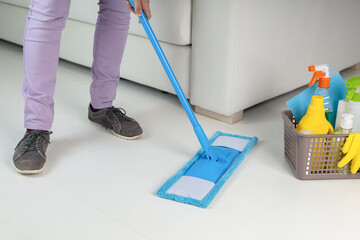 housemaid cleaning floor in room close-up.Woman doing chores.