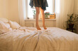 © Evgenij Yulkin/Stocksy - Little girl jumping on the bed