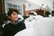 © Maria Manco/Stocksy - boy hides behind snow fort for snowball fight
