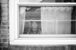 © Maria Manco/Stocksy - photo of girl through window