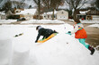 © Maria Manco/Stocksy - kids sledding in front yard