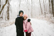 © Maria Manco/Stocksy - kids hug in snowy woods