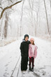 © Maria Manco/Stocksy - kids hug in snowy woods